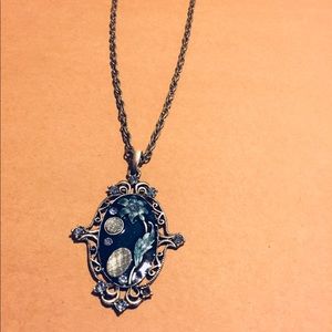 Flourishing blue pendant accented on link chain
